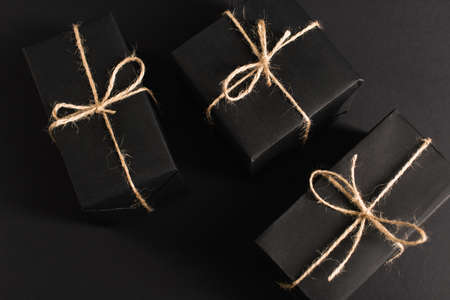 top view of wrapped dark gift boxes on blackの写真素材