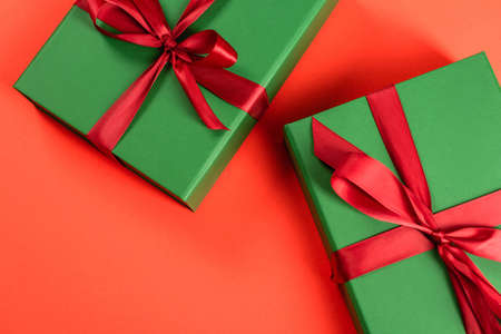 top view of green wrapped presents on red backgroundの写真素材