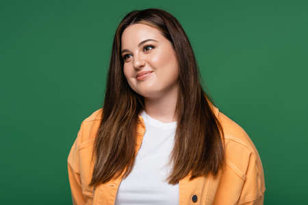 Pretty woman with overweight smiling away isolated on green