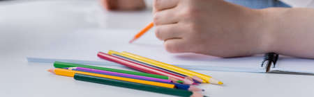Cropped view of woman drawing near color pencil at home, bannerの写真素材