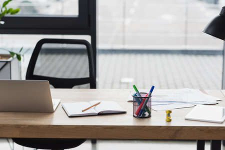 Devices and notebook on table in office
