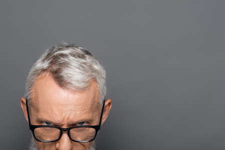 cropped view of bearded middle aged businessman in glasses isolated on grayの写真素材