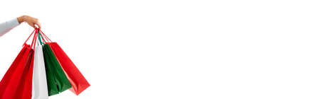 cropped view of woman holding shopping bags isolated on white, bannerの写真素材