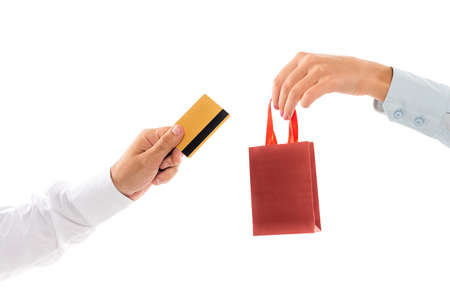 cropped view of woman holding shopping bag near male hand with credit card isolated on whiteの写真素材