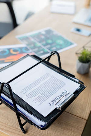 High angle view of contract on paper tray on table in officeの写真素材