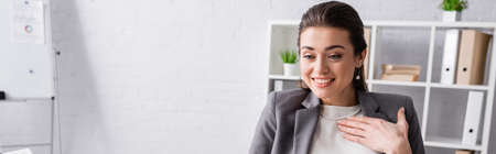 happy businesswoman smiling in modern office, bannerの写真素材