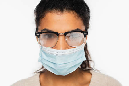 African american woman in fogged eyeglasses and medical mask isolated on whiteの写真素材