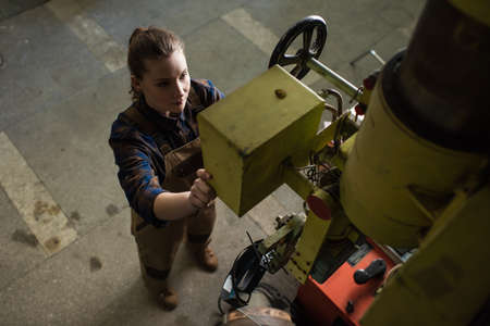 High angle view of welder standing near welding machine in factory