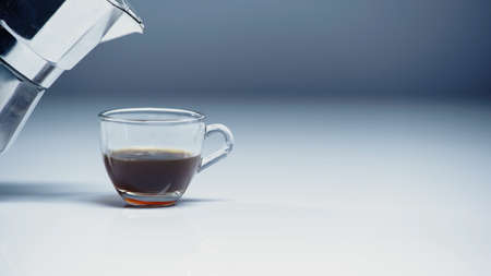 coffee maker near glass cup with coffee on white and grey,stock imageの写真素材