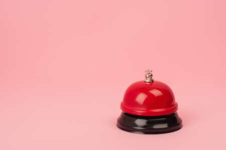 red and metallic bell isolated on pinkの写真素材