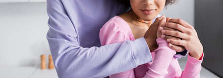 Cropped view of african american man holding hands of girlfriend at home, banner