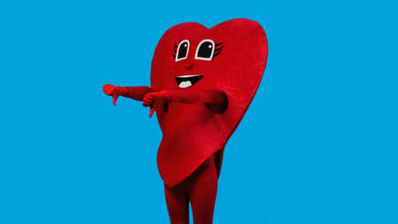 person in red heart costume showing thumbs down isolated on blueの写真素材