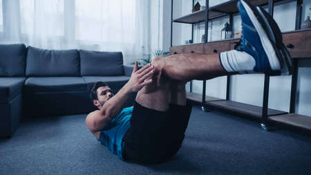 young and sportive man working out on floor