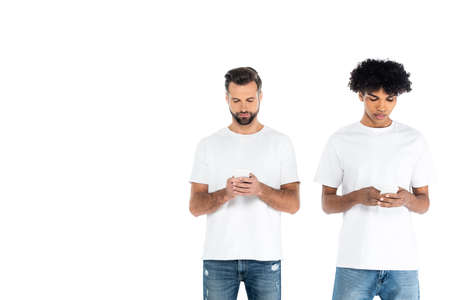 multiethnic men in t-shirts chatting on mobile phones isolated on whiteの写真素材