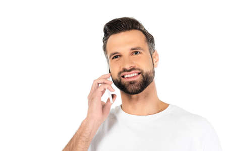cheerful bearded man talking on mobile phone isolated on white