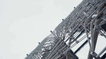 bottom view of old radar station in chernobyl zone against gray sky