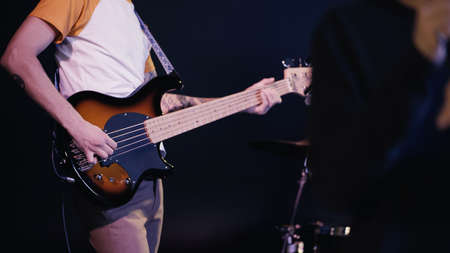 KYIV, UKRAINE - DECEMBER 30, 2021: cropped view of guitarist playing on stage