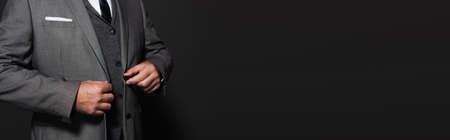 cropped view of businessman in blazer on dark gray background, banner