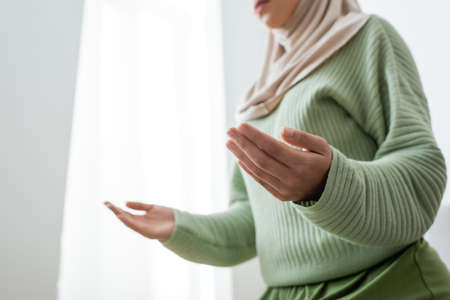 Low angle view of muslim woman praying at home