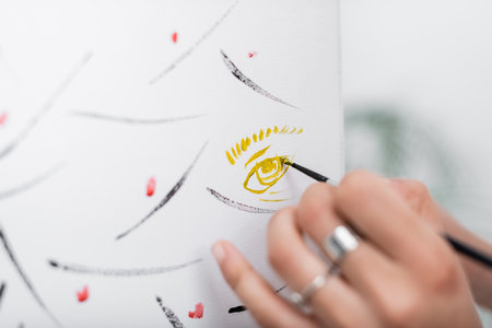 Cropped view of blurred african american woman painting on canvas at homeの写真素材