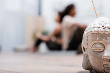 Incense stick near blurred african american couple at homeの写真素材