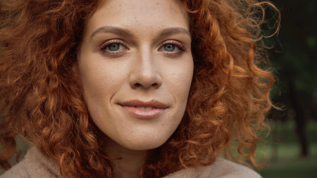 close up of happy redhead woman with blue eyes