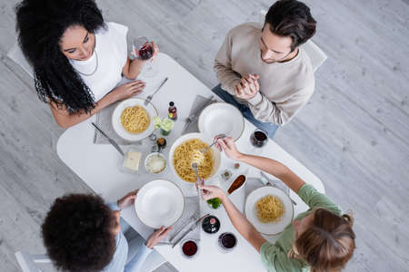 top view of multiethnic friends having lunch togetherの写真素材