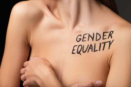 partial view of nude woman with gender equality lettering on body