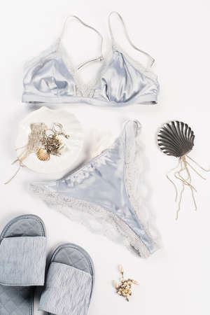 Top view of slippers near lingerie and accessories on white backgroundの写真素材