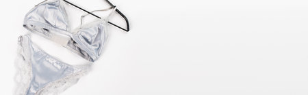 Top view of lingerie on hanger on white background with copy space, bannerの写真素材