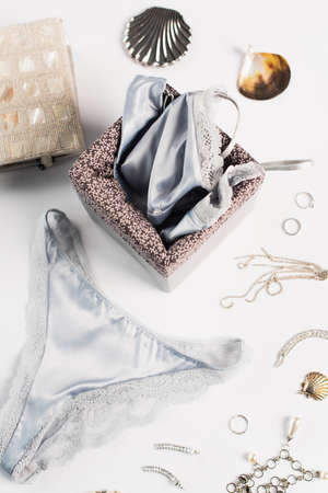 Top view of lingerie, accessories and bag on white backgroundの写真素材