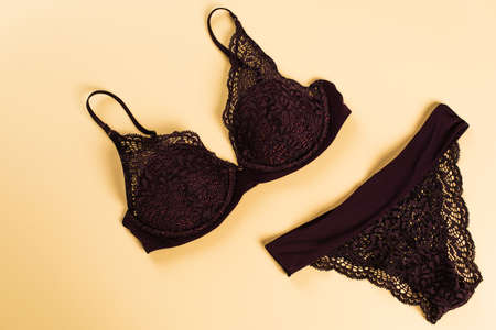 Top view of black lace lingerie on beige backgroundの写真素材