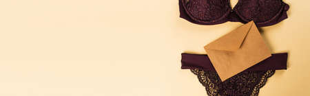 Top view of lace lingerie and envelope on beige background, bannerの写真素材