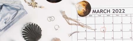 Top view of march calendar, bra and accessories on white background, bannerの写真素材