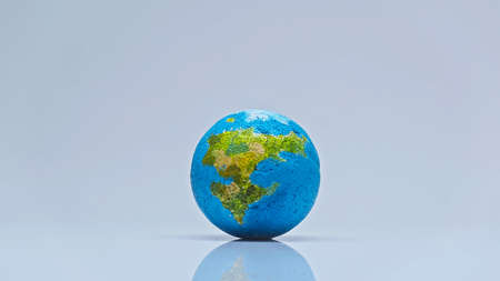 blue globe on grey background with copy space, environmental concept