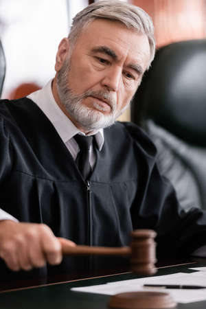 senior judge with blurred gavel sentencing in courtの写真素材