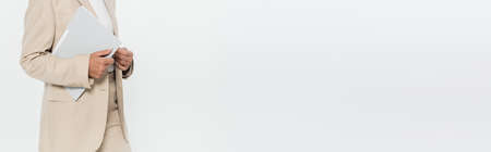 Cropped view of businesswoman in formal wear holding paper folder isolated on grey, bannerの写真素材