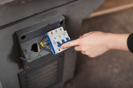 Cropped view of furniture designer turning on jointer machine