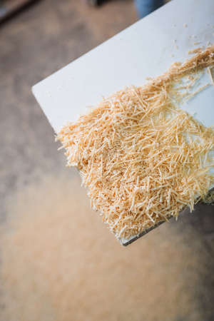 Top view of wooden sawdust on plank in workshopの写真素材