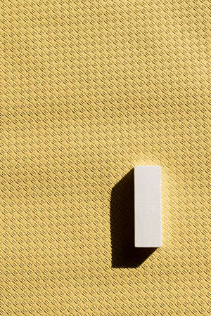 top view of white rectangular block on beige textured background with copy spaceの写真素材