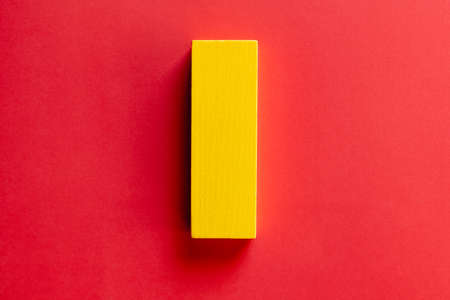 top view of rectangular yellow block on red backgroundの写真素材