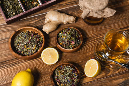 Top view of tea, lemons and honey on wooden surfaceの写真素材