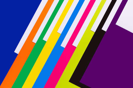 diagonal stripes of colorful paper sheets on blue background