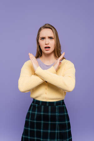 shocked young woman showing no gesture isolated on purpleの写真素材