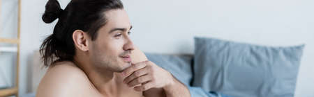 smiling and shirtless man thinking at home, bannerの写真素材