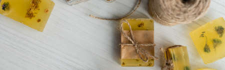 Top view of craft soap bars near twine on table, bannerの写真素材