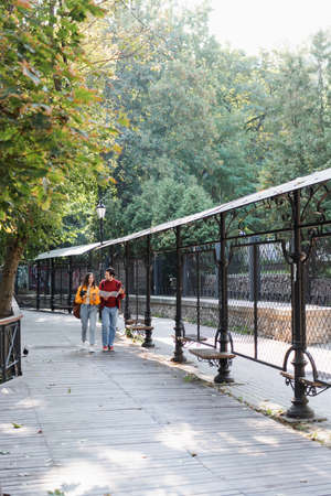 Travelers with coffee, binoculars and map walking on urban streetの写真素材