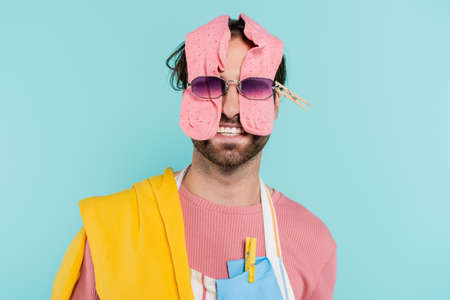 Smiling man in sunglasses and clothes isolated on blueの写真素材