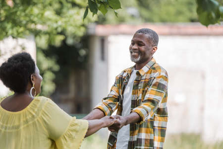senior african american couple smiling and dancing in parkの写真素材