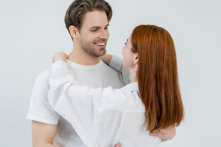 Young redhead woman embracing boyfriend isolated on whiteの写真素材
